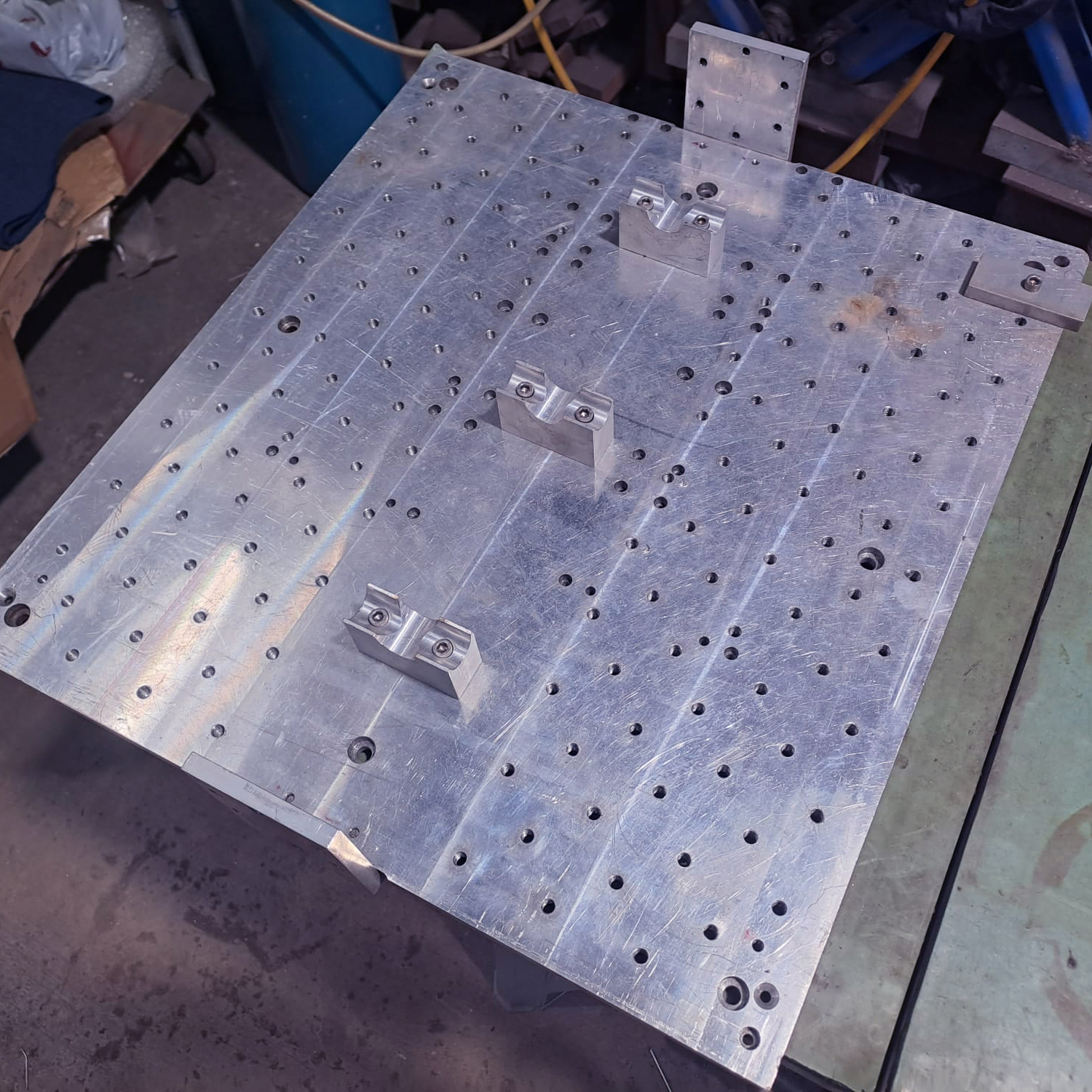 Aluminium fixture with holes and fittings
