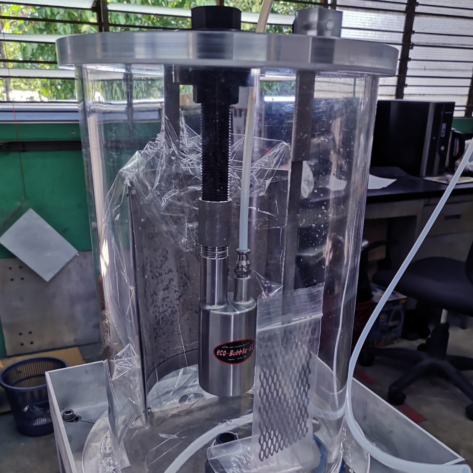Cylindrical acrylic tank with steel components and pipes