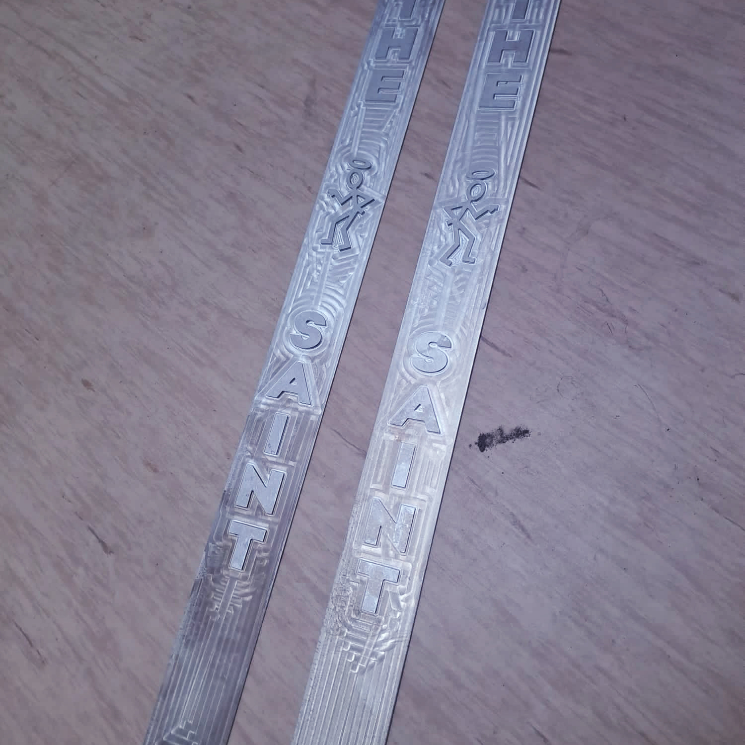 Two patterned aluminum car door sills
